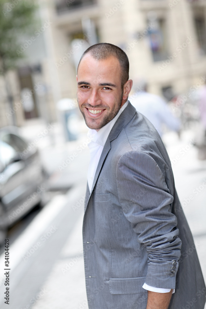 Cheerful young man walking in town Cheerful young man walking in town