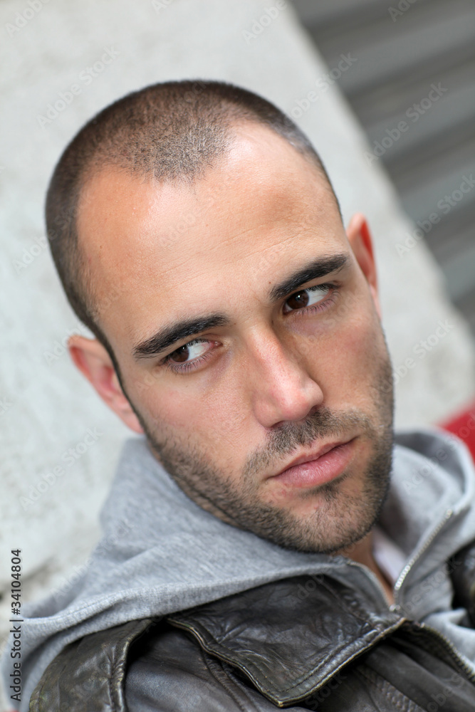 Fototapeta premium Portrait of bad boy waiting in the street
