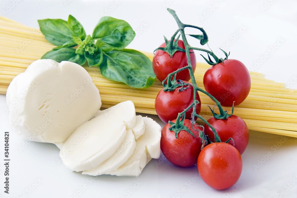 Italian food: spaghetti, mozzarella, cherry tomatoes and basil