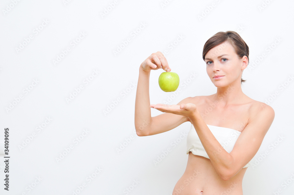 Beautiful woman holding green apple in hand Beautiful woman holding green apple in hand