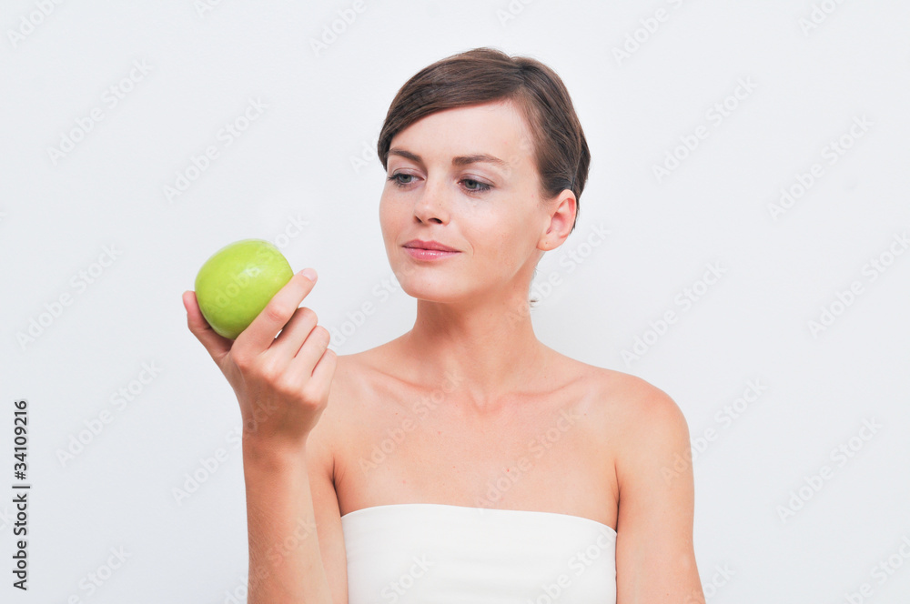 Beautiful woman holding green apple in hand Beautiful woman holding green apple in hand