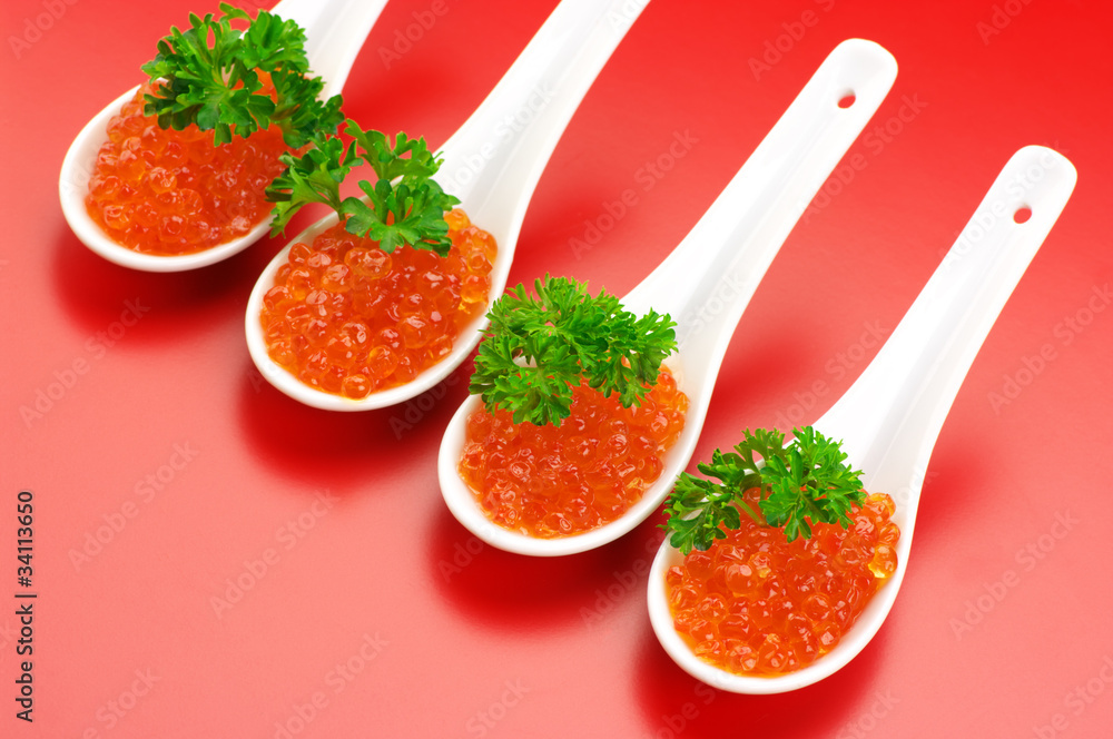 Salmon caviar in spoons Salmon caviar in spoons