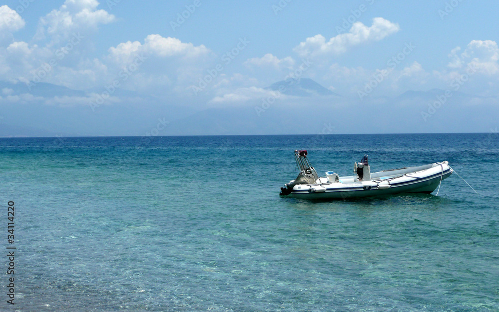 Inflatable boat anchored on the pebble beach