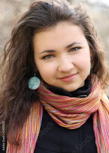 Portrait of a beautiful young brunette with curly hair