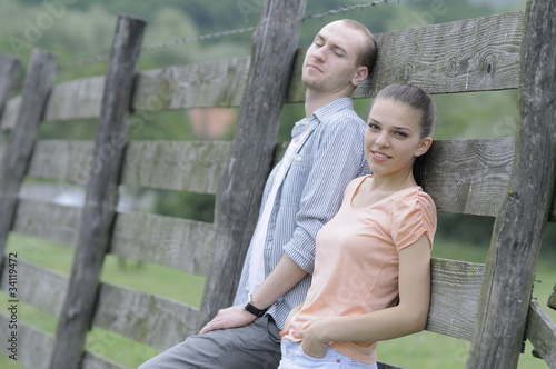 beautiful young man and woman relaxing outside