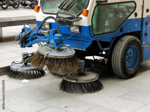 machine cleaning dust from sidewalk