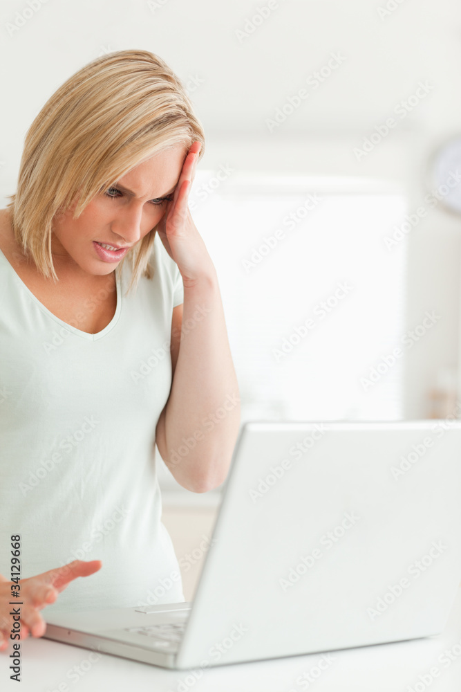 Woman looking at her laptop not knowing what to do Woman looking at her laptop not knowing what to do