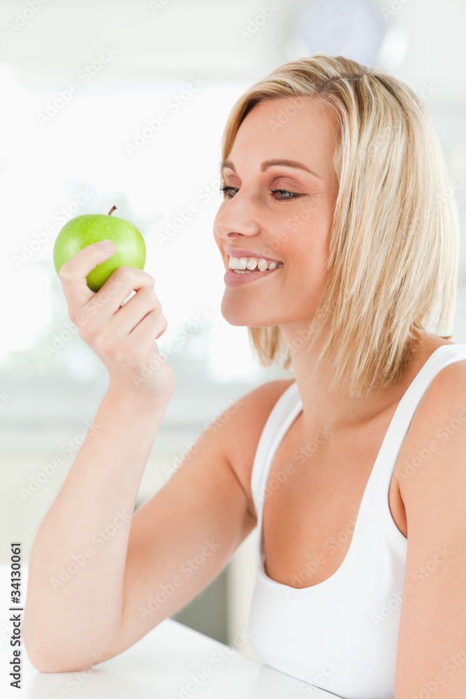 Young smiling woman watching a green apple Young smiling woman watching a green apple