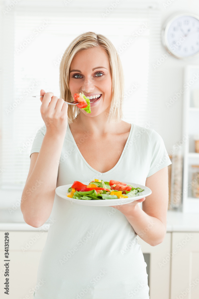 Portrait of a charming woman enjoying mixed salad Portrait of a charming woman enjoying mixed salad