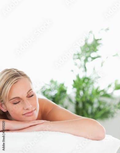 Close up of a cheerful blonde woman lying on a lounger