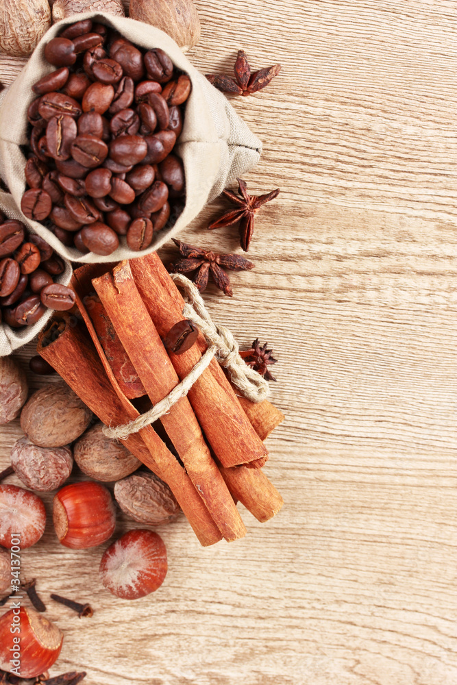 cinnamon, coffee, nutmeg and hazelnut on a wooden background cinnamon, coffee, nutmeg and hazelnut on a wooden background