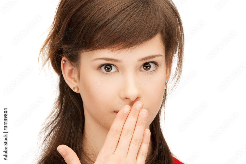 teenage girl with palms over mouth teenage girl with palms over mouth