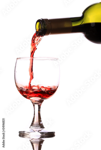 Red wine pouring down into a wine glass
