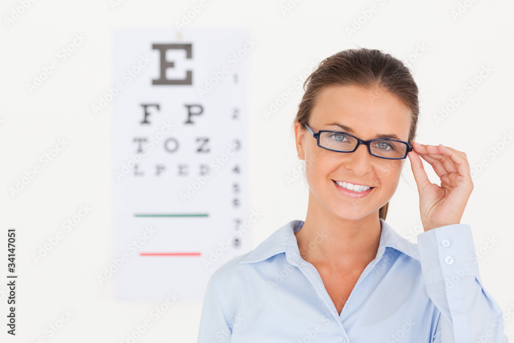 Good looking eye specialist wearing glasses looking into the cam Good looking eye specialist wearing glasses looking into the cam