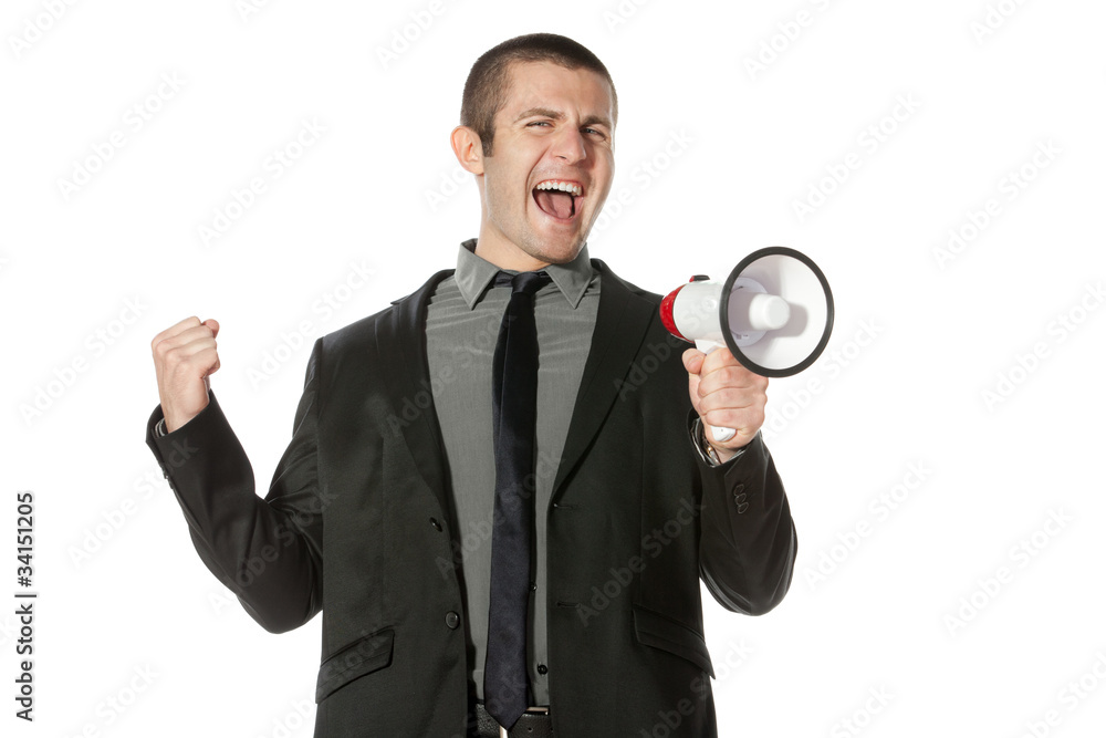 Portrait of a young business man yelling into a megaphone. Portrait of a young business man yelling into a megaphone.