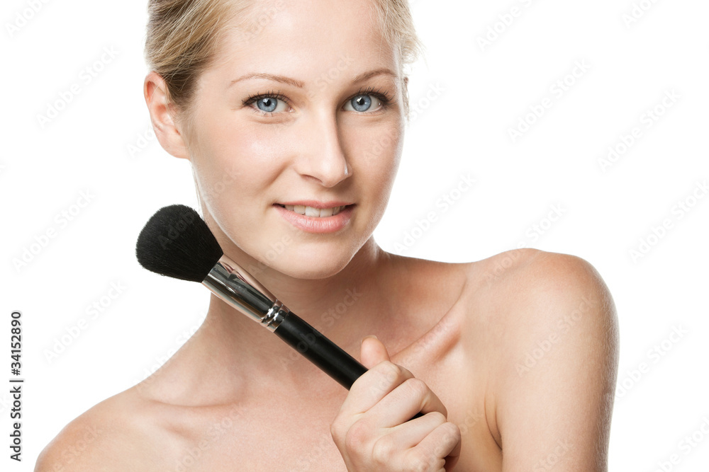 Youngfemale applying mineral powder with make-up brush