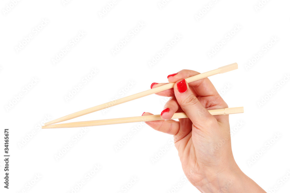 woman's hand and wooden chopsticks isolated on white woman's hand and wooden chopsticks isolated on white