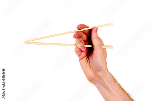 woman's hand and wooden chopsticks isolated on white