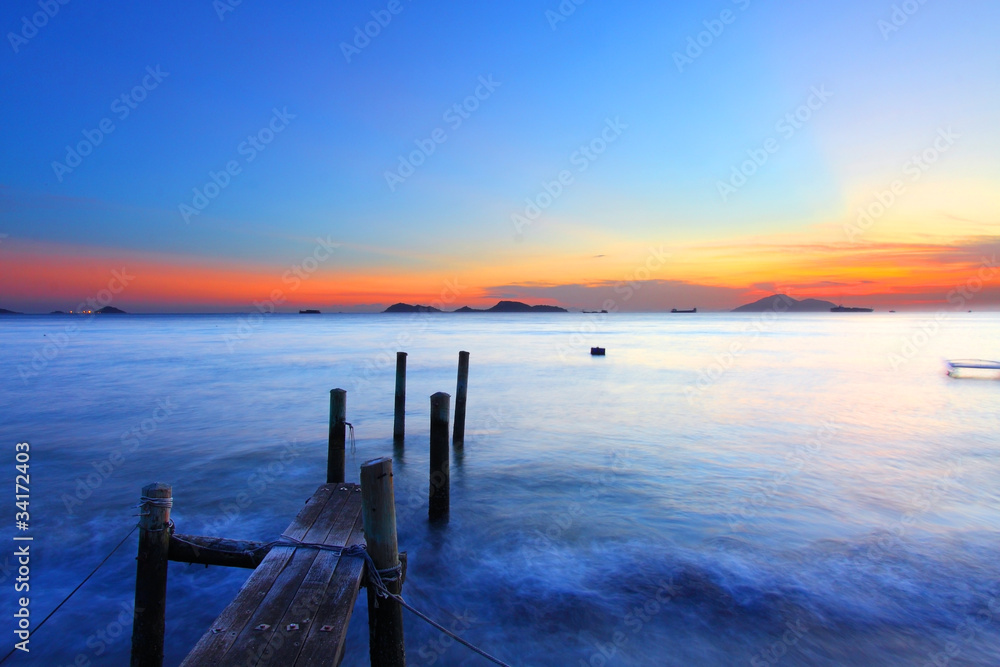 Sunset along a wooden pier in Hong Kong Sunset along a wooden pier in Hong Kong