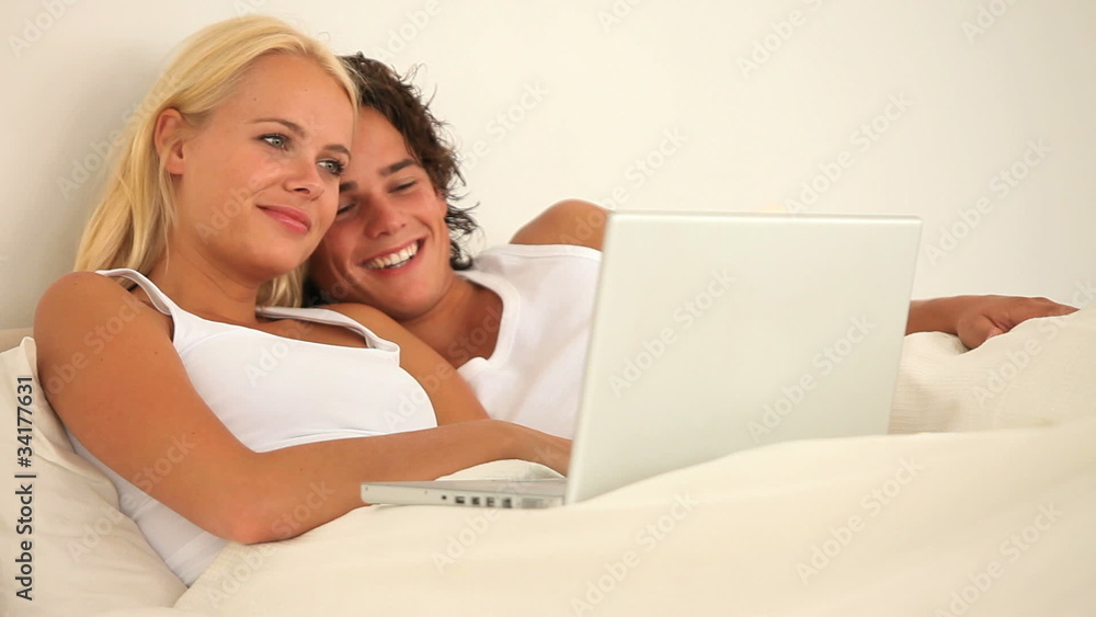 Cheerful lovely couple with a laptop Cheerful lovely couple with a laptop