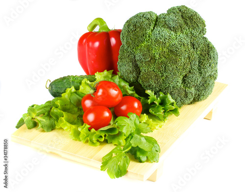 fresh and juicy vegetables on the wood plate isolated