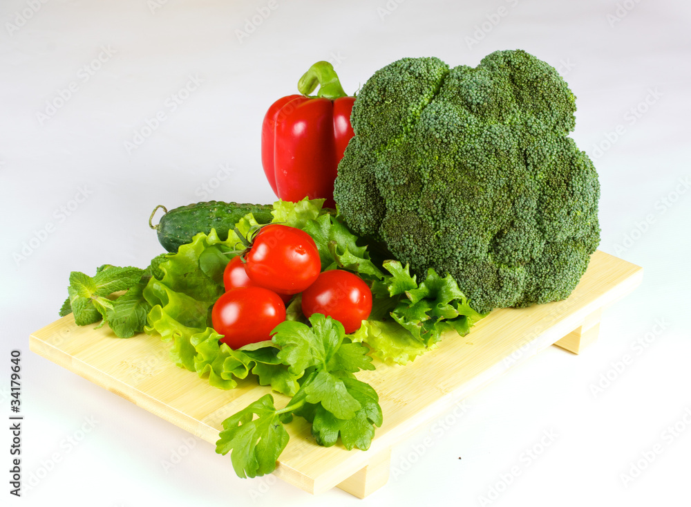 fresh and juicy vegetables on the wood plate isolated fresh and juicy vegetables on the wood plate isolated