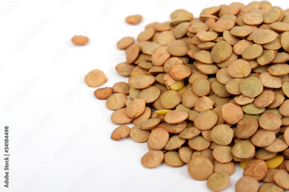Pile of green lentils from low perspective isolated on white. Pile of green lentils from low perspective isolated on white.