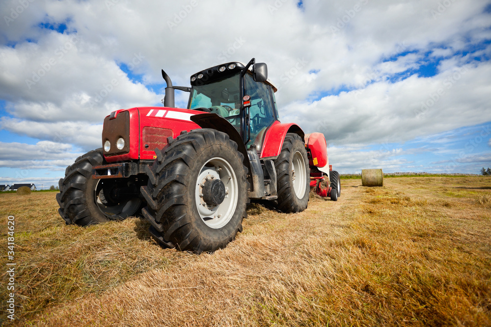 tractor collecting haystack in the field tractor collecting haystack in the field