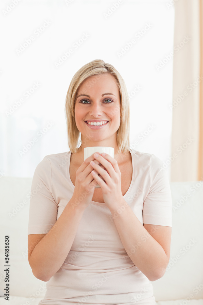 Portrait of a smiling woman holding a cup of tea Portrait of a smiling woman holding a cup of tea