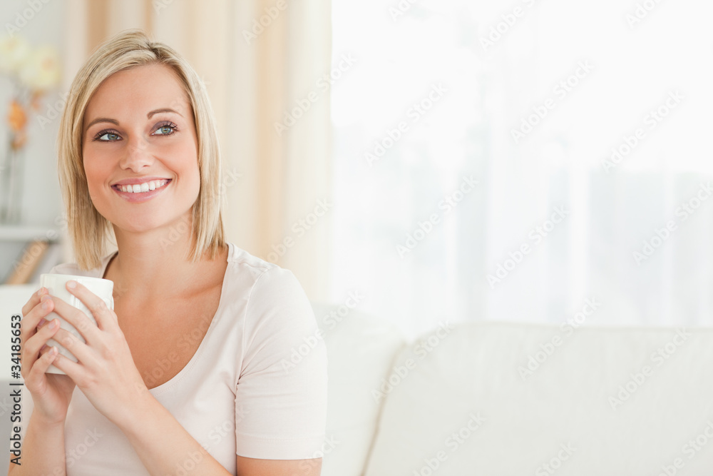 Smiling woman holding a cup of coffee Smiling woman holding a cup of coffee