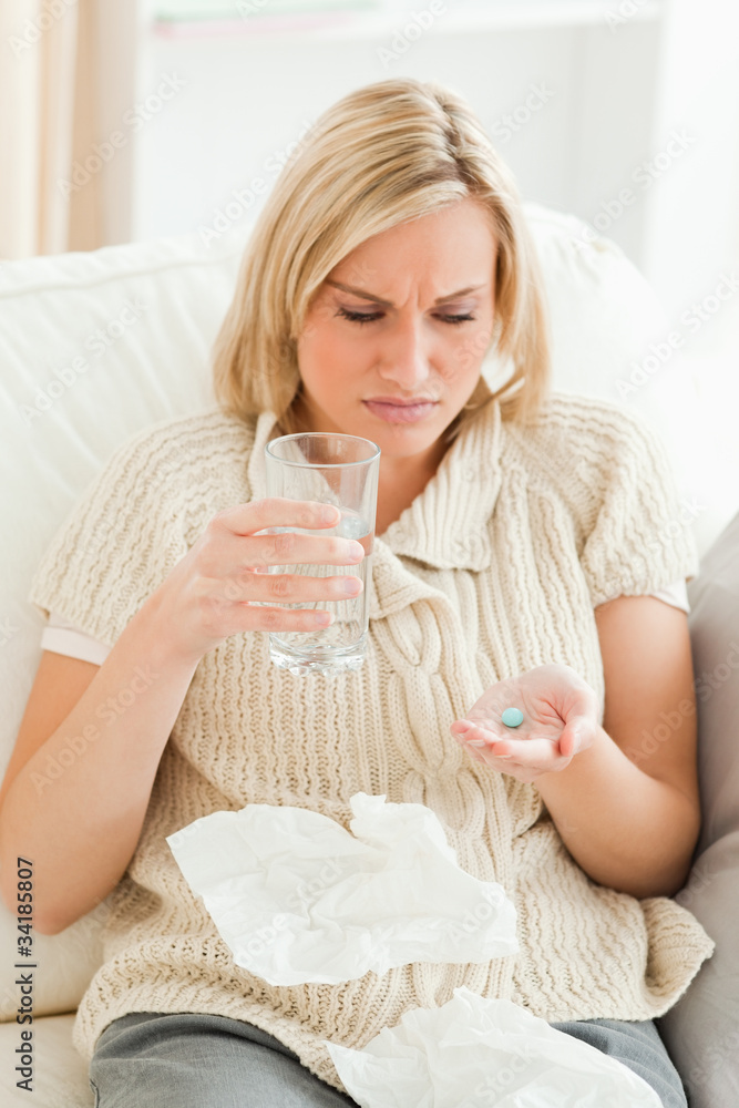 Portrait of a tired woman taking her treatment