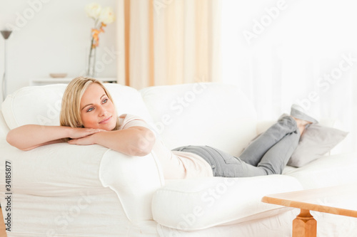 Calm woman lying on her sofa