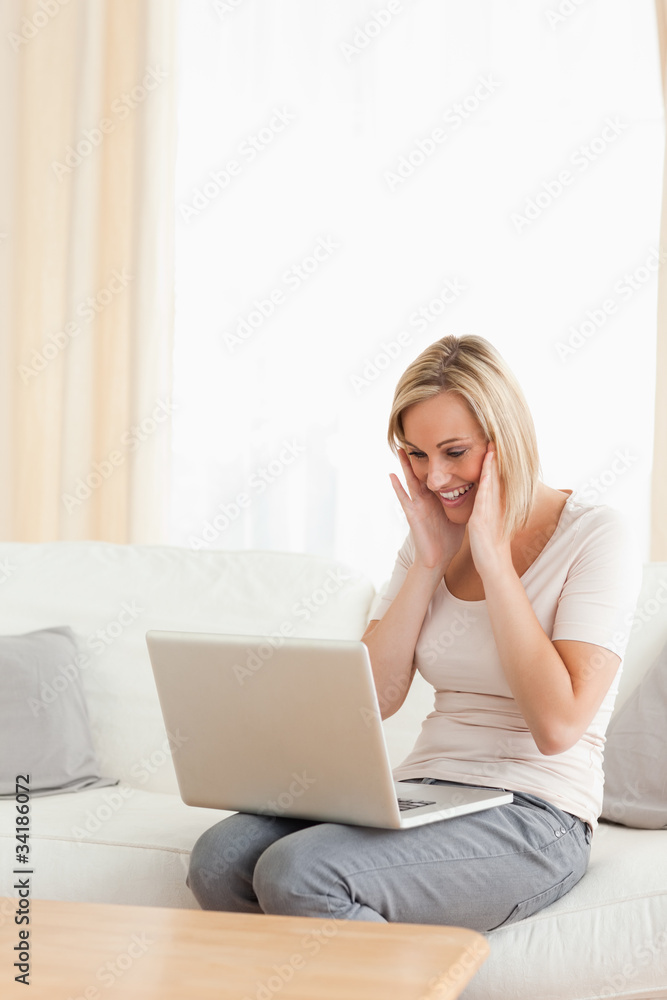 Portrait of a happy woman looking at her laptop Portrait of a happy woman looking at her laptop