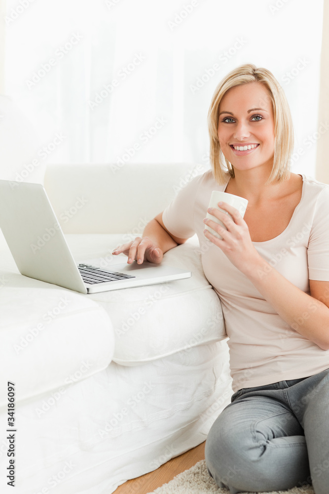 Portrait of awoman holding a mug while with a notebook Portrait of awoman holding a mug while with a notebook