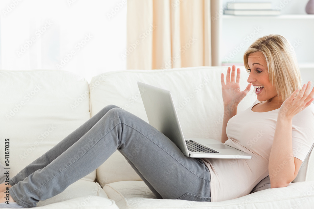 Upset blonde woman having trouble with her laptop Upset blonde woman having trouble with her laptop