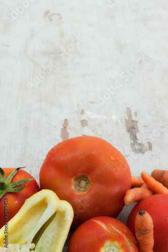 tomatoes, pepper and carrots on wooden board