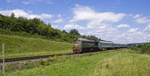 Diesel locomotive with passenger cars photo