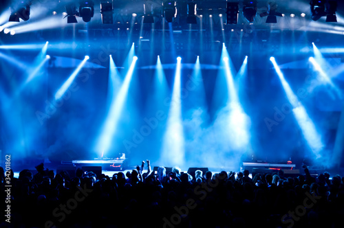 concert crowd in front of bright blue stage lights
