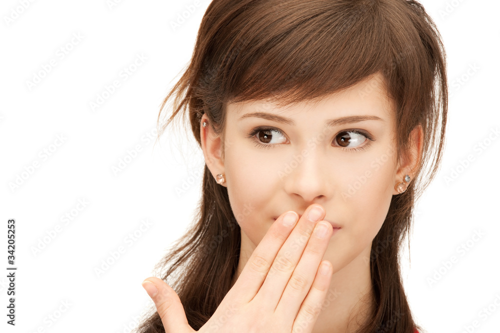 teenage girl with palms over mouth teenage girl with palms over mouth
