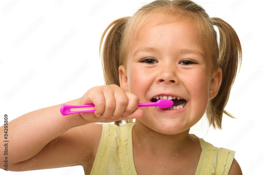 Little girl is cleaning teeth using toothbrush Little girl is cleaning teeth using toothbrush
