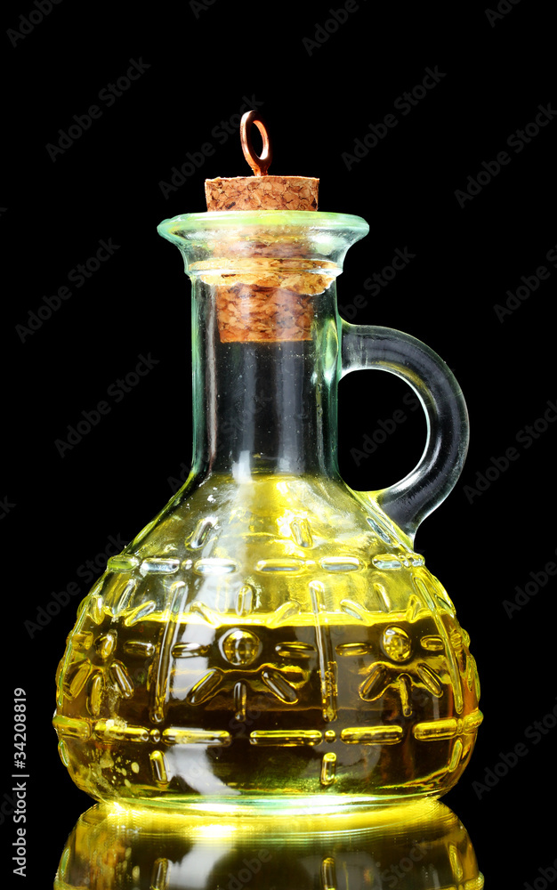 olive oil in jar on black background olive oil in jar on black background