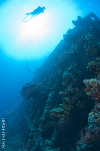Fototapeta Naklejka Na Ścianę i Meble -  Divers exploring a large shipwreck