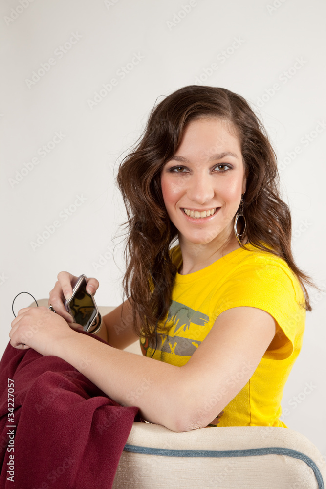 girl in yellow blouse smiling at the camera