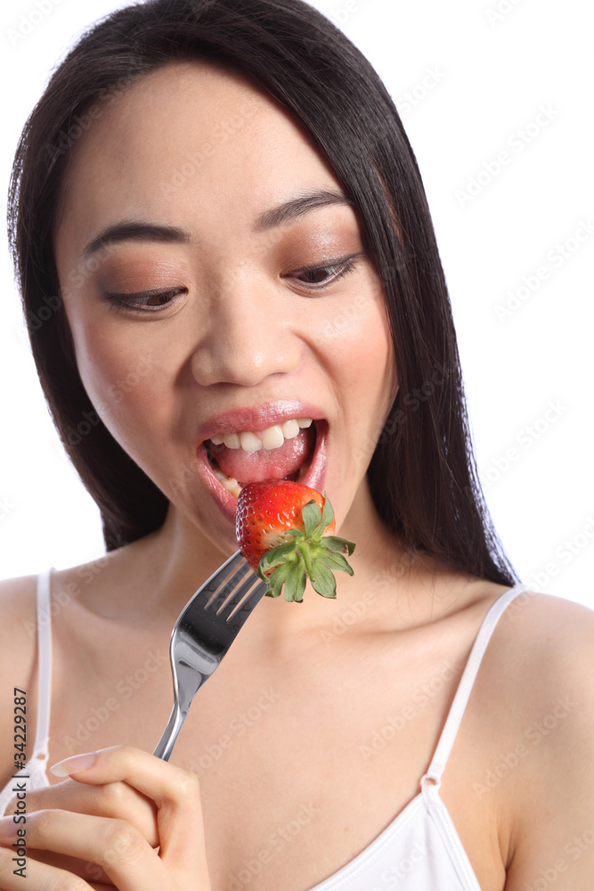 Beautiful chinese teenager girl eating strawberry Beautiful chinese teenager girl eating strawberry
