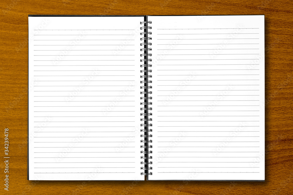White open notebook on beech wood background. White open notebook on beech wood background.