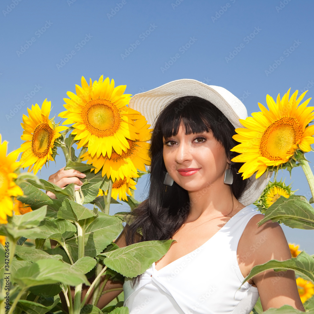 Young woman in the field of sunflowers Young woman in the field of sunflowers
