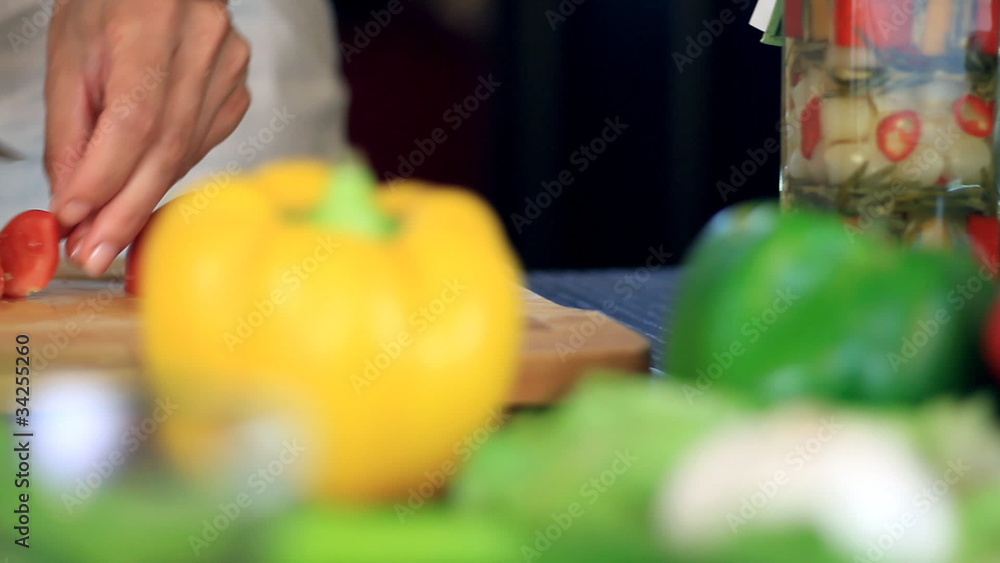 Female hands slicing red tomato, dolly shot Female hands slicing red tomato, dolly shot