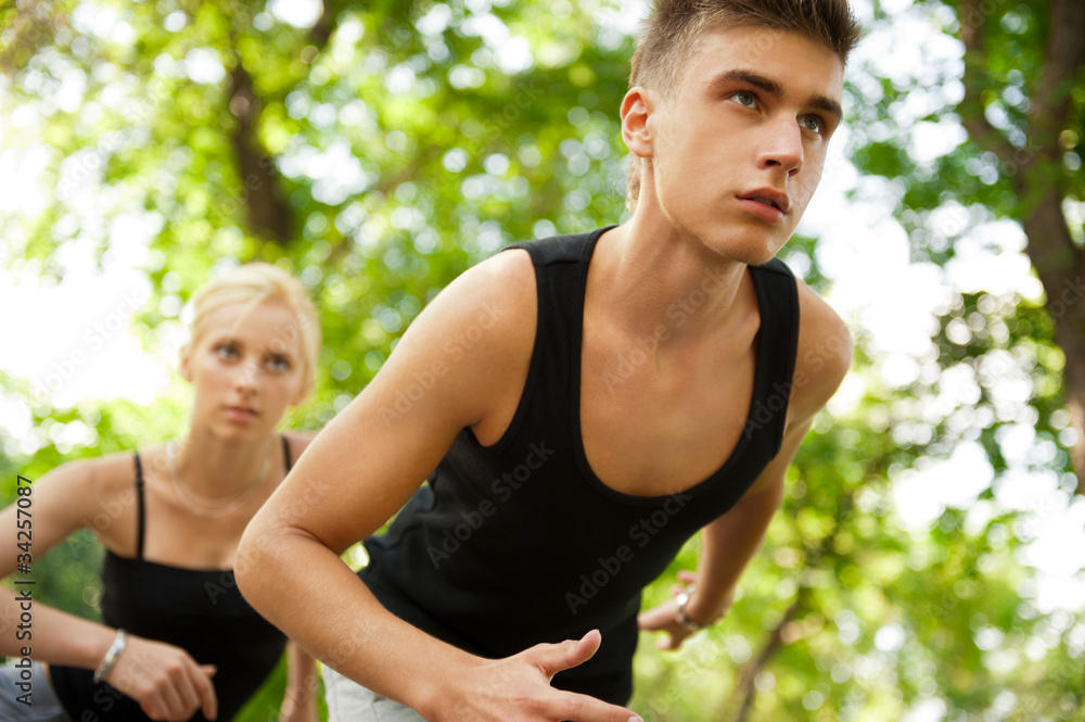 Closeup Portrait of Young Couple Jogging In Park Closeup Portrait of Young Couple Jogging In Park