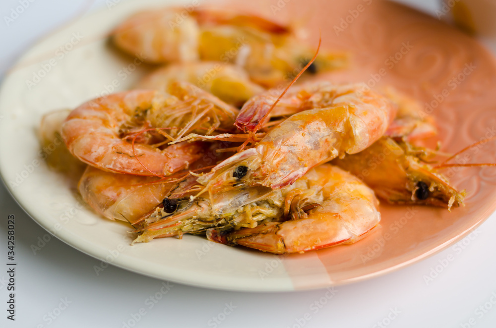 Baked shrimp with salt on white & orange dish Baked shrimp with salt on white & orange dish