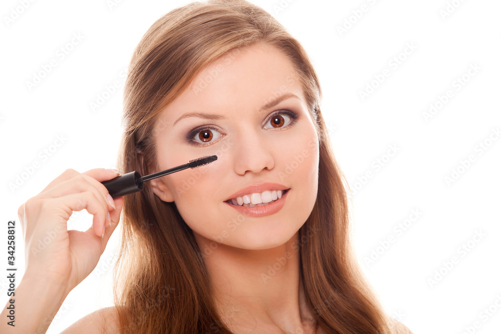 beautiful woman applying mascara on her eyelashes beautiful woman applying mascara on her eyelashes